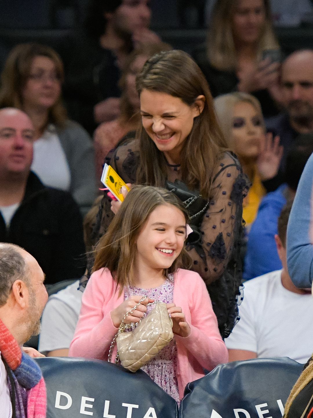 Suri Cruise (Right) and Katie Holmes attend a basketball game between the Detroit Pistons and the Los Angeles Lakers at Staples Center on January 15, 2017 in Los Angeles, California.