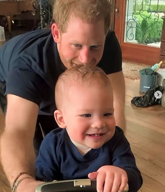 Prince Harry is seen crawling on all fours with his son Archie in a cute home video