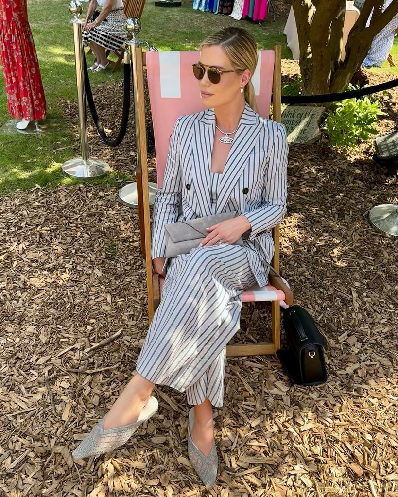 Amelia Spencer wearing a suit on a deck chair