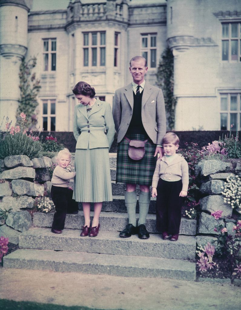 Queen Elizabeth II and Prince Philip, Duke of Edinburgh with their two younger children, Princess Anne and Prince Charles, outside Balmoral Castle, September 19, 1952.
