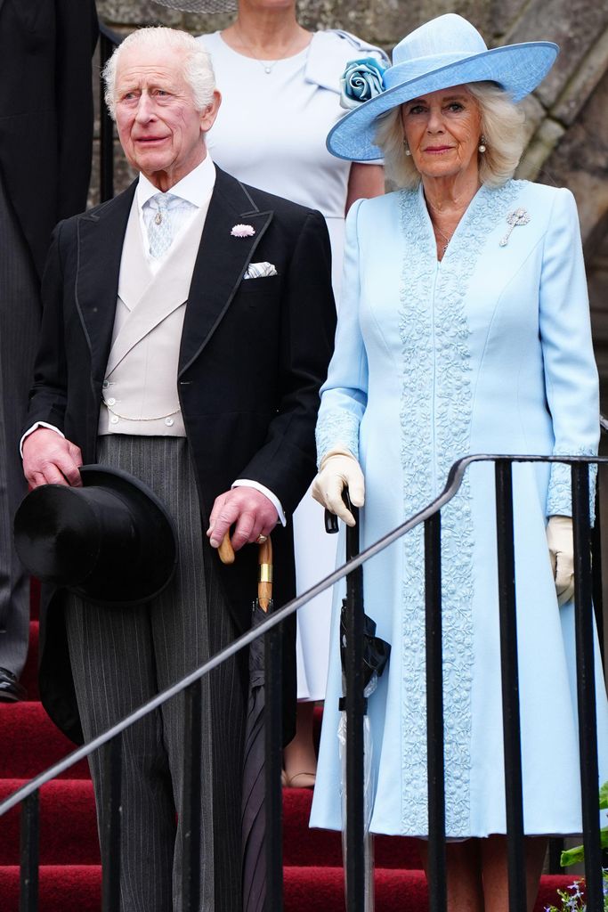 King Charles and Queen Camilla, wearing blue coats at a Scottish garden party
