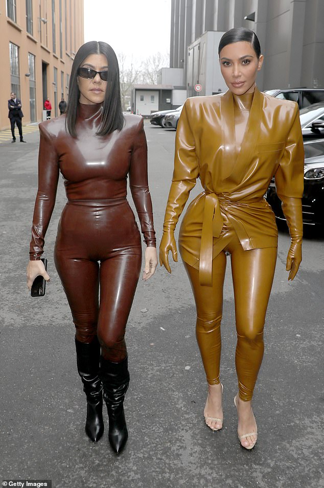 She matched with her sister Kourtney who wore a similar tight latex two piece in chocolate brown