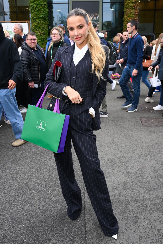 Sophie Hermann in a pinstripe suit at Wimbledon