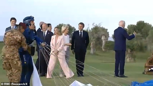 Biden appeared to walk away from other world leaders at the G7 summit last month (pictured). The White House has insisted he was waving to paratroopers, who were not pictured on screen, but his actions were nevertheless unusual