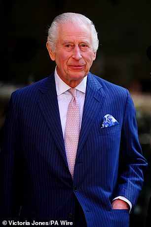 The King's favourite pink dinosaur-centred tie is a coded reference to his new title Charles III Rex (C-Rex). Above: Her Majesty wearing the tie during her visit to University College Hospital Macmillan Cancer Centre in April