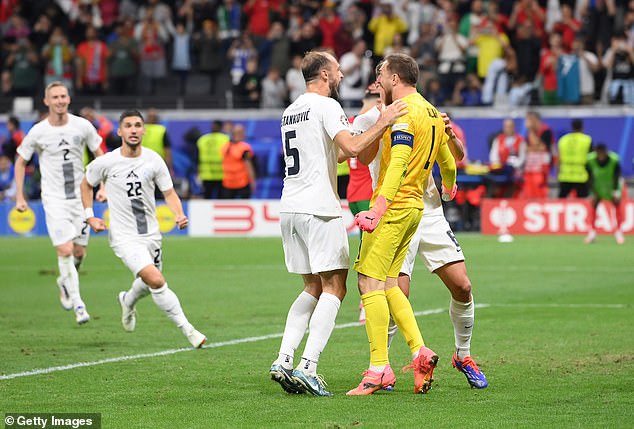 The Slovenia captain was congratulated by his teammates after his brilliant penalty save