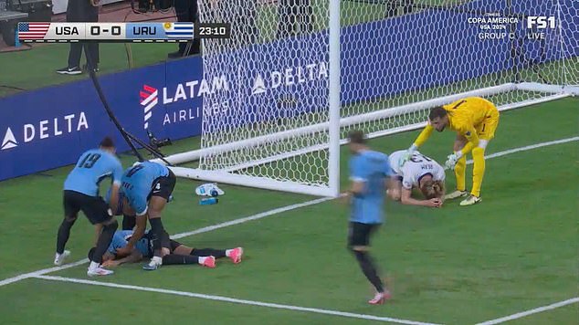Uruguay star Maximiliano Araujo is stretchered off with his neck in a BRACE after scary clash of heads left teammates begging for medical help