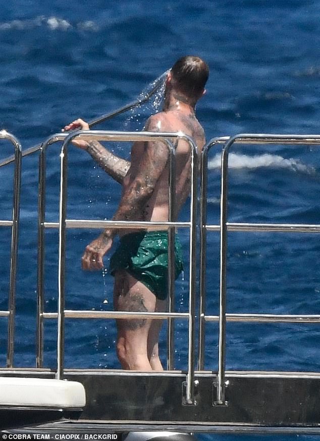 David took respite from the Sardinian heat by taking a shower on the deck before meeting up with his wife