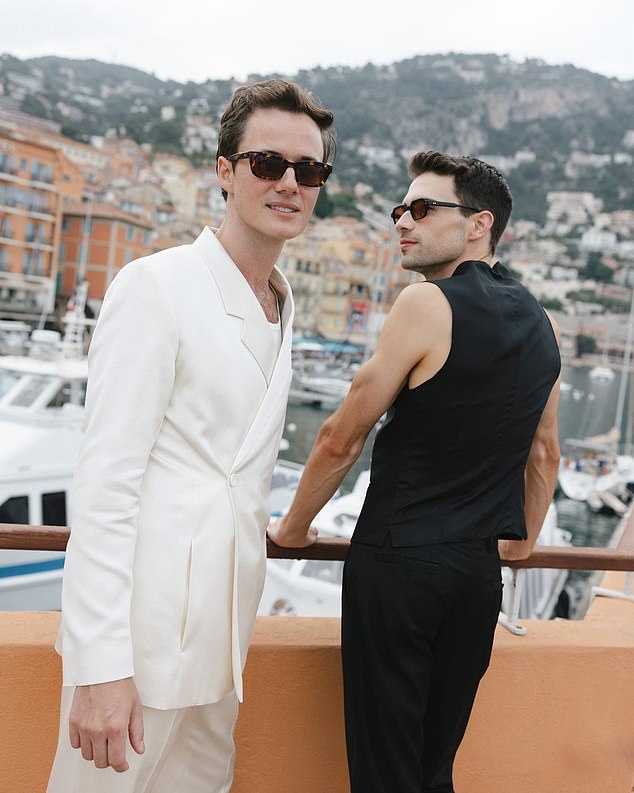 In photos from the first day of the festival, Alexander (left) looked dapper in a stylish cream suit, tortoise shell sunglasses and tan leather boots
