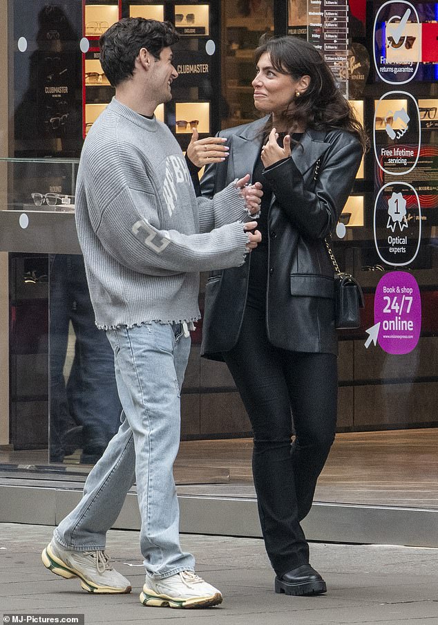 Paul next to her wore a light grey jumper which he paired with casual denim jeans and white trainers