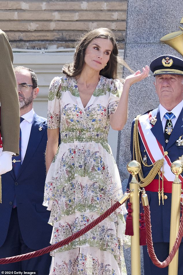Letizia was seen battling with the wind during the ceremony, which ruffled her hair and dress