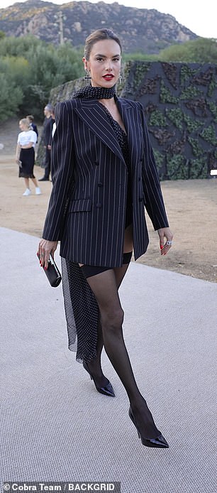 Following behind was Alessandra who put on a very leggy display in a pinstripe and polka dot blazer jacket, which featured a tailcoat, and a matching one-shoulder leotard