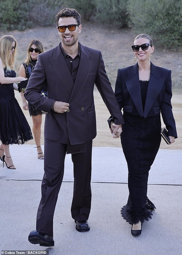 The Gentleman star Theo James, 39, looked dapper as ever as he stepped out in a tailored black lined blazer and some matching trousers (pictured with girlfriend  Ruth Kearney)
