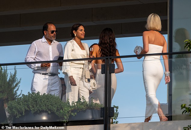 Ahead of their arrival, a number of lesser-known guests were spotted strolling around the sports legend's palatial property dressed in eye-catching outfits.