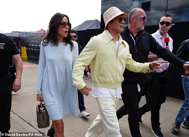 The actor, 60, looked loved-up with the beauty, 34, as they commanded attention while walking around the paddock