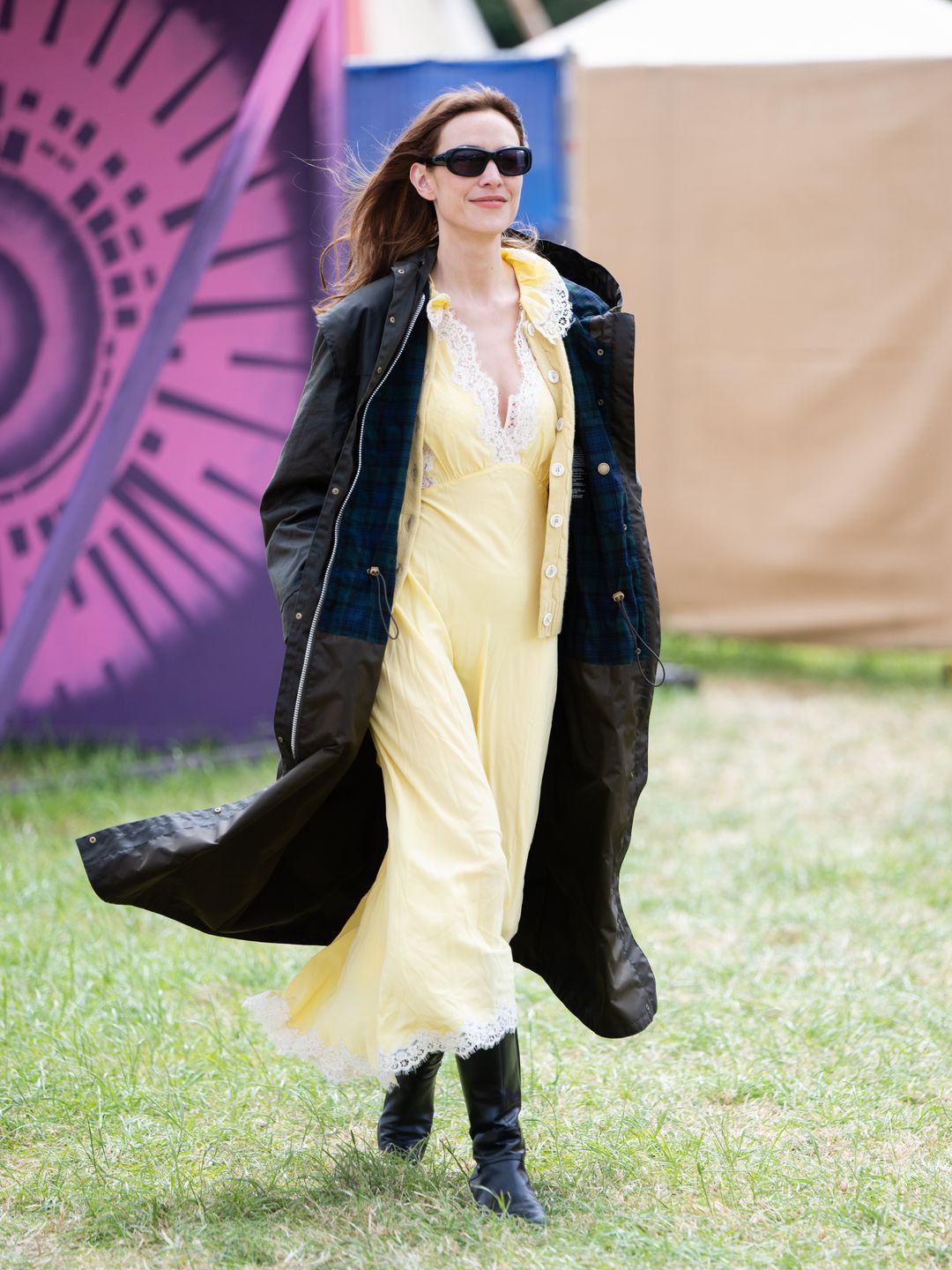 Alexa Chung on day three of Glastonbury in a yellow slip dress and jacket from the Barbour collaboration.