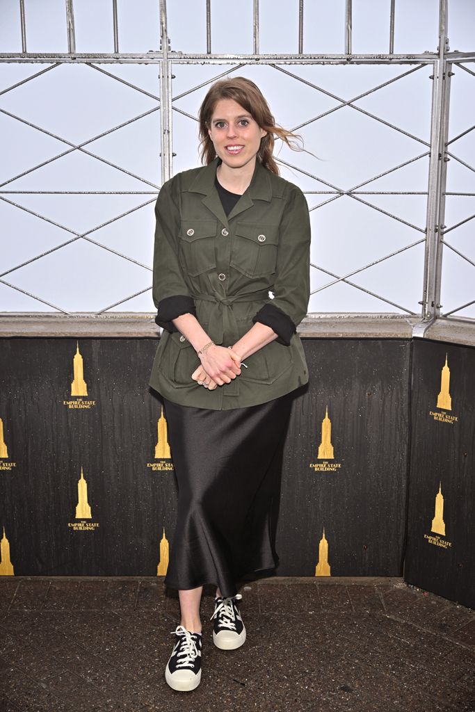 Princess Beatrice in a black skirt and khaki jacket