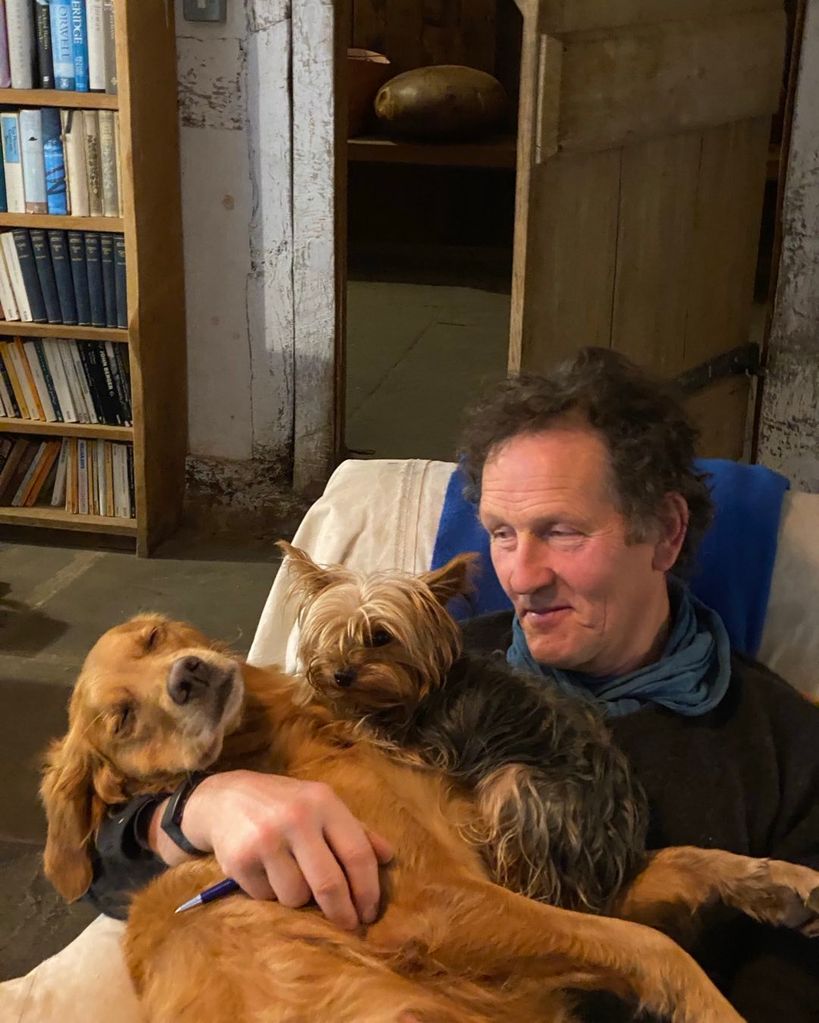 Monty Don caressing two pet dogs 