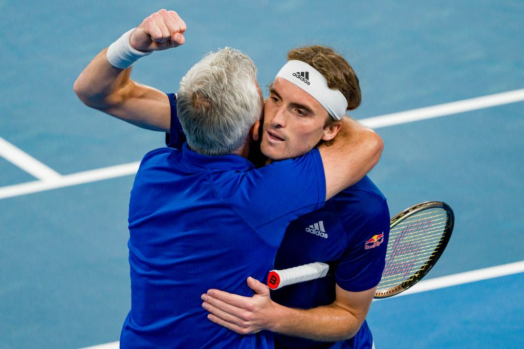 father and son celebrating on the tennis court