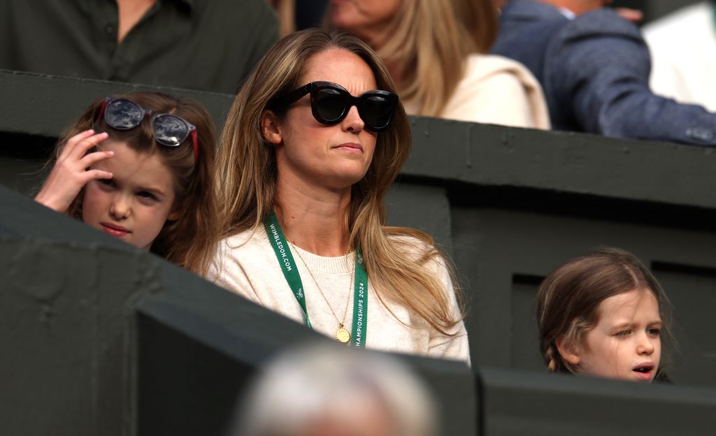 Kim Murray playing tennis with two little girls